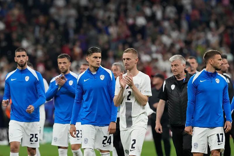 Slovenias players react at the end of match against Portugal 